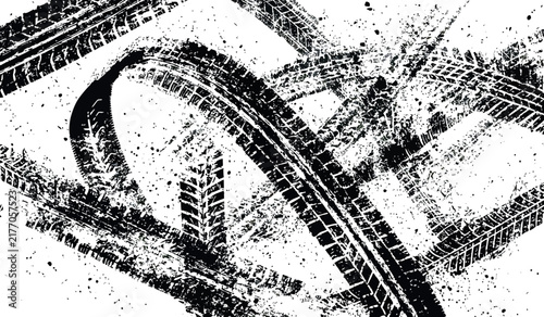 Black tire tracks splattered on white background with dynamic motion and abstract grunge texture for automotive themes