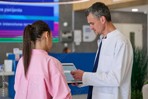 Canvas Print Doctor discusses treatment options with patient in modern medical facility on a