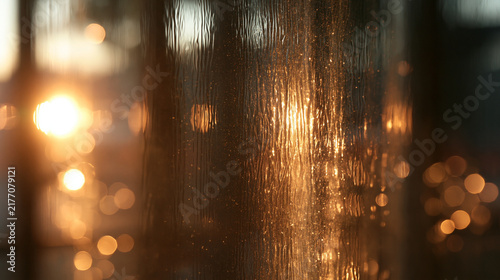 Raindrops and Golden Bokeh Lights on Textured Glass Window
