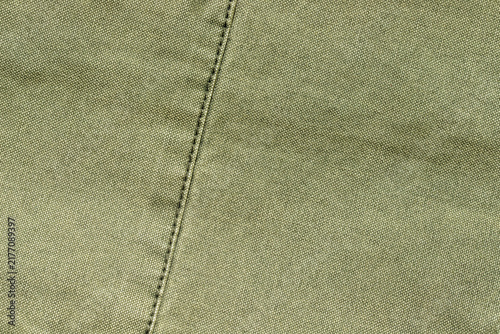 olive green canvas fabric texture background with stitched seam detail