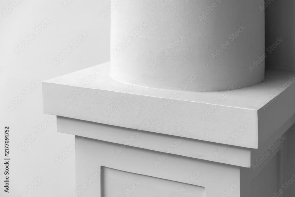 Obraz premium Close-up of a white architectural column base and pedestal showcasing clean lines, subtle texture and minimalist classical design. Neutral tones emphasize shape, geometry and architectural details