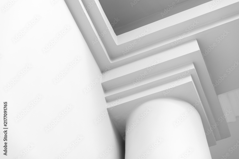 Obraz premium A minimal close-up of a white architectural column and layered molding, emphasizing clean geometric lines, soft shadows and sleek modern design for abstract, interior and architectural compositions