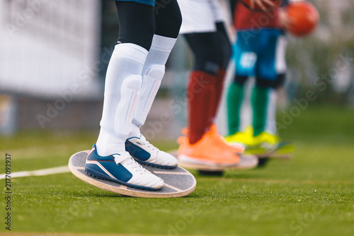 Young Athlete Balancing on Wobble Board on Turf Pitch - Junior Soccer Propriocetion and Core Stability Balance Training Session