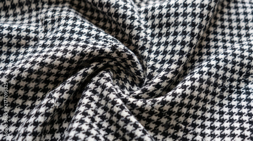 Crumpled black and white houndstooth fabric texture background