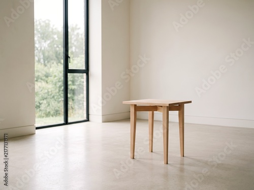 Minimalist wooden side table in a bright modern room