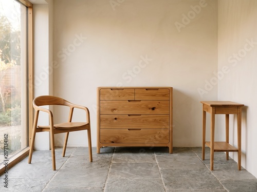 Wooden chest of drawers with chair and side table in a modern room