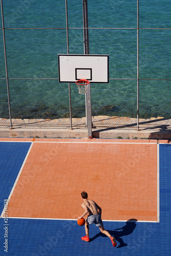 Basketball player on the court by the sea