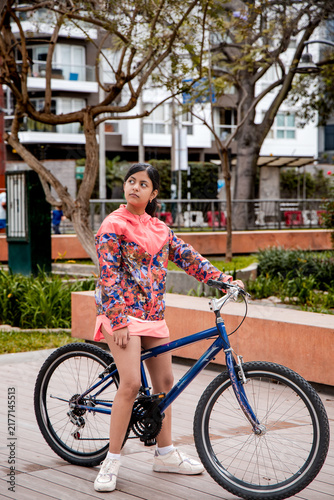 Full Length Portrait of a Teen Girl With Her Bicycle in the City