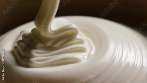 White soft serve dessert spirals onto a plate in layered creamy motion
