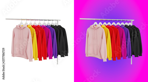 Fotografía A row of colorful hoodies hanging on a metal clothing rack, including pink, yell