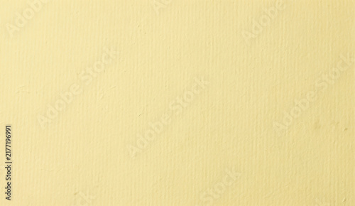 Soft yellow organic paper surface featuring fine natural fibers and earthy shades, as a eco friendly canvas paper