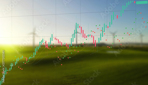 Fotografía Financial trading stock chart overlay on green field with wind turbines representing renewable energy market investment and ESG economy growth