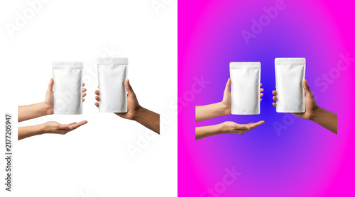 Bild auf Leinwand Two hands holding blank white stand up pouches for food or cosmetic packaging mo