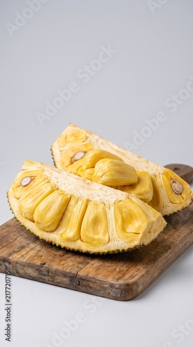 Canvastavla Ripe yellow jackfruit pods on a wooden cutting board, studio lighting