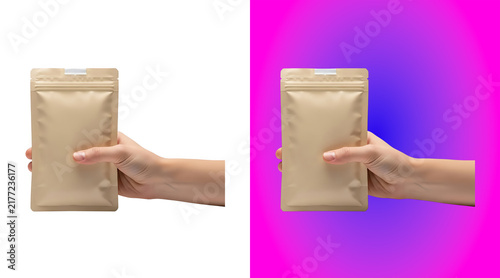 Bild auf Leinwand A human hand holding a blank beige stand-up pouch bag for food packaging, isolat