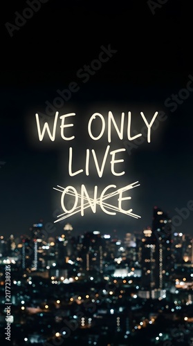 We only live once neon text over blurred city night