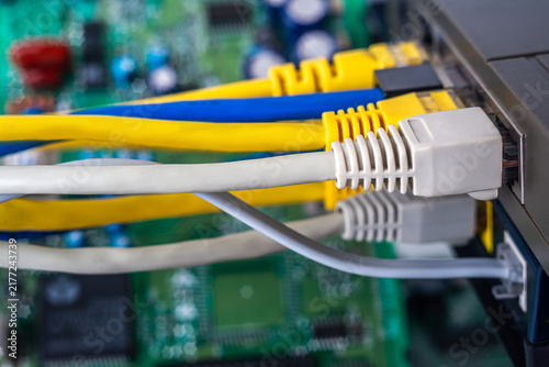 Wires connect to a network switch in a computer hardware setup in a tech environment