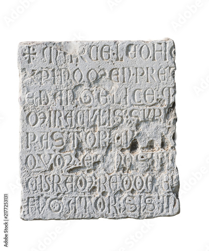 A square white stone slab with carved ancient inscriptions