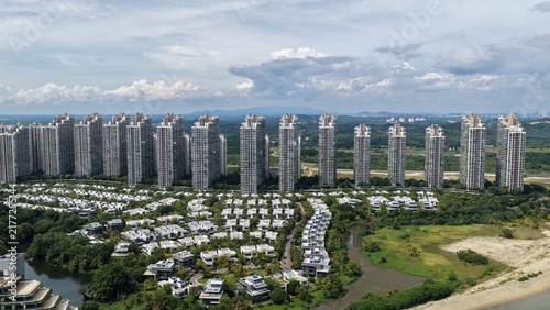 Aerial view of Forest City with modern high-rise residential towers and low-rise villas surrounded by lush greenery and coastal landscape in Gelang Patah, Johor Darul Ta'zim, Malaysia.