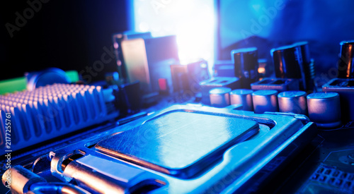 Obraz na plátně Closeup motherboard cpu socket with metal processor and blue neon lighting for t