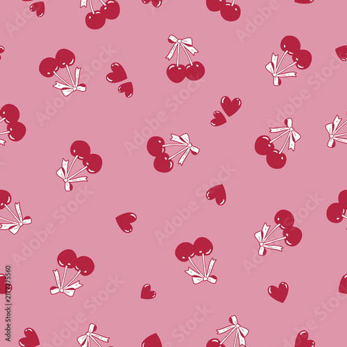 Sweet cherries with bows and hearts scattered on a soft pink background seamless pattern