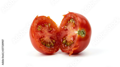 Fresh ripe red tomato cut in half revealing juicy seeds and pulp on a plain background transparent background