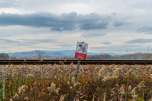 Canvastavla Railway no trespassing warning sign beside an active track near Jezioro Mucharskie