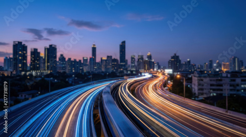 Digital light trails on highway with city skyline at dusk, vibrant urban scene with dynamic motion and colorful lights