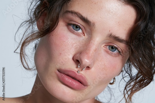 Portrait of young woman with facial piercings