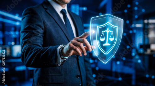 Lawyer touching virtual shield icon with scales of justice symbolizing legal protection justice and law enforcement in digital technology and cyber security context.