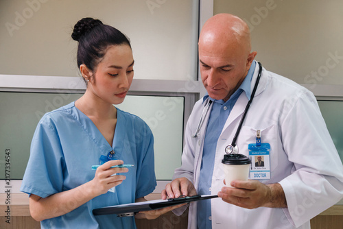 professor doctor give advice and discuss with intern student for surgery planning and patient treatment in the hospital medical school. healthcare and medical education concept.