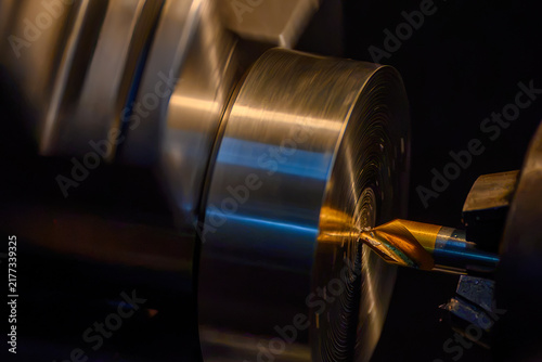 Pilot drilling process on metal shaft parts using a coated center drill tool on a lathe machine