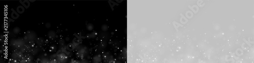 A field of scattered white glowing particles floats upward against a deep black background. The particles vary in size, creating a soft, ethereal bokeh effect.