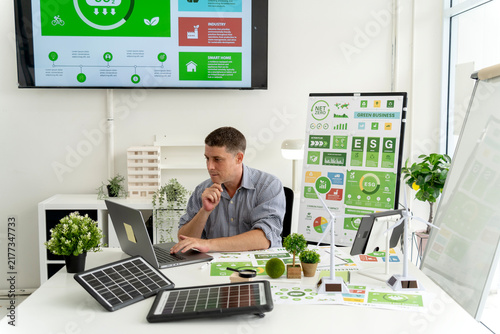 Young Professional Man Working on Sustainable ESG Business Strategy with Green Energy Solar Panel