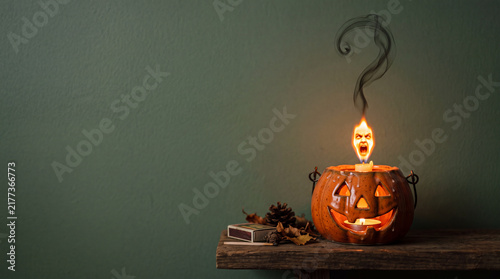 Jack-o'-Lantern Flame Shaped Like Screaming Face, Halloween Object on Solid Green Background with Copy Space