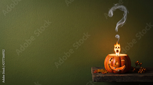 Jack-o'-Lantern Flame Shaped Like Screaming Face, Halloween Object on Solid Green Background with Copy Space