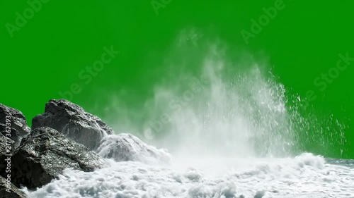 Ocean wave crashing against rocks isolated on green screen for easy compositing and vfx water splash