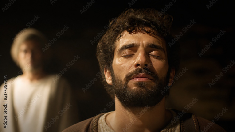 Fototapeta premium Man sleeping peacefully while angel appears in background with soft light. Biblical scene of divine dream and angelic visitation