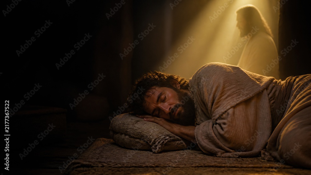 Fototapeta premium Man sleeping in dark room with divine light and angelic figure appearing behind. Biblical Joseph receiving angel message in
