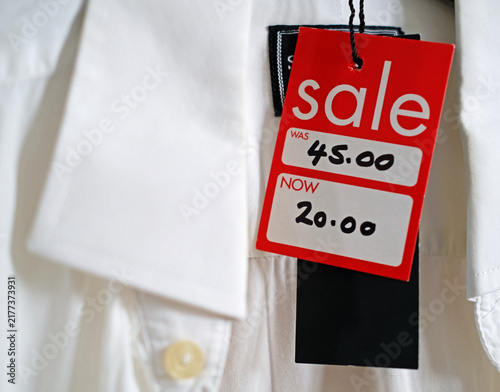 Cuadro en lienzo For sale tag hanging from a traditional, formal white shirt