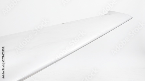close-up of an airplane wing across a white background
