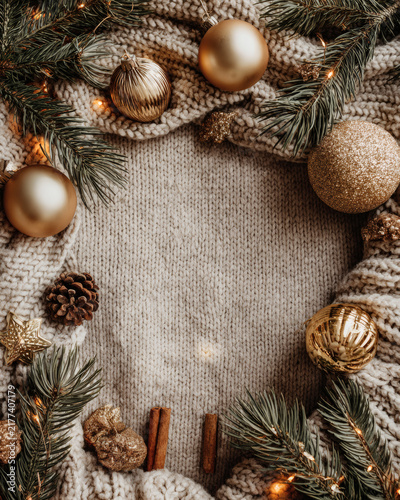 christmas frame with fir branches and cones on wood