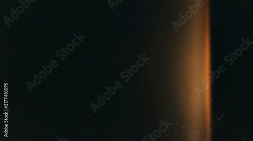 Abstract background texture featuring a warm vintage ember film wash effect with soft orange light leaks on dark black backdrop