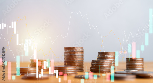 Cuadro en lienzo Stacks of coins with stock market graphs and candlestick charts overlay