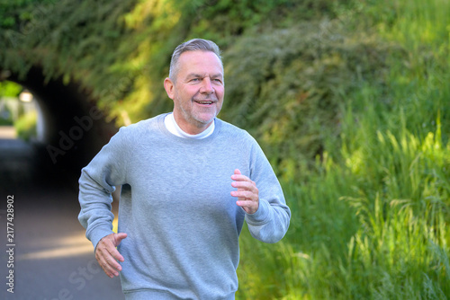 Active Senior Jogging Through Nature