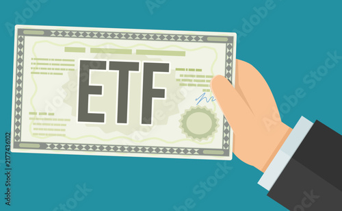 Businessman hand holding an ETF exchange traded fund share certificate on teal background representing stock market index investing, asset portfolio, and financial growth