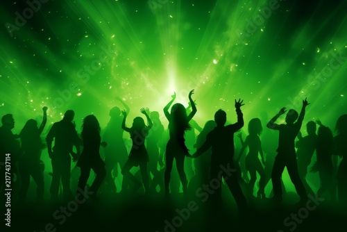 Partygoers dancing together in a nightclub with vibrant green light beams and energy particles