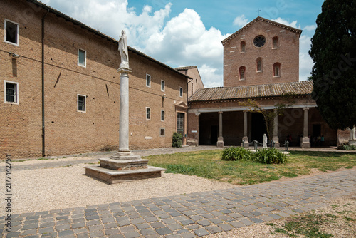 Canvastavla Courtyard with marble column statue and historic brick facade at the Abbey of Tr