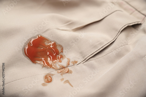 Fotografie red tomato ketchup stain on khaki fabric
