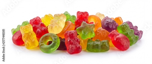 Colorful gummy bears scattered on white background